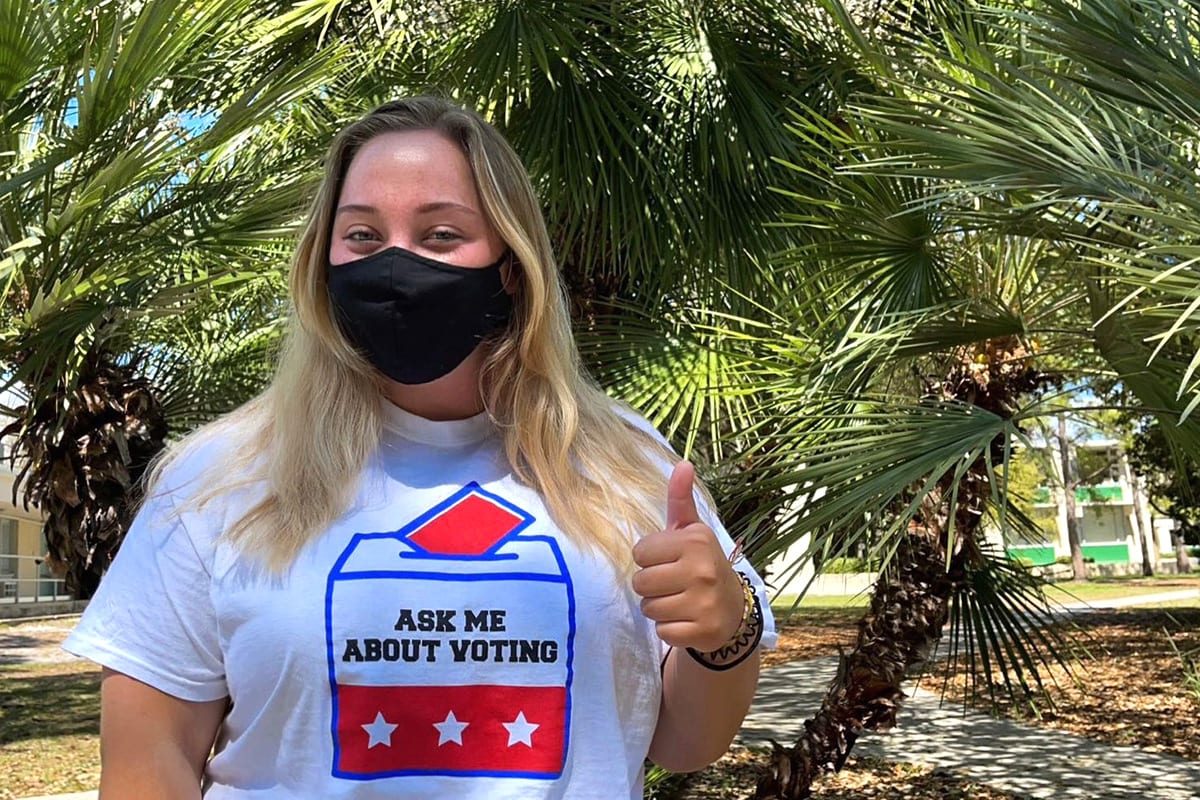 Student wearing "Ask me about voting" shirt