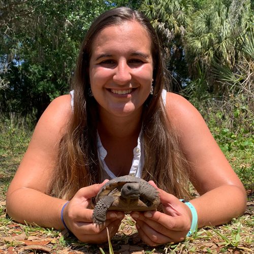 Student holds a baby Gopher Tortoise