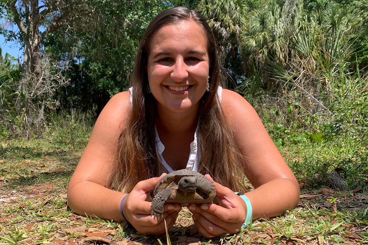 Student holds a baby Gopher Tortoise
