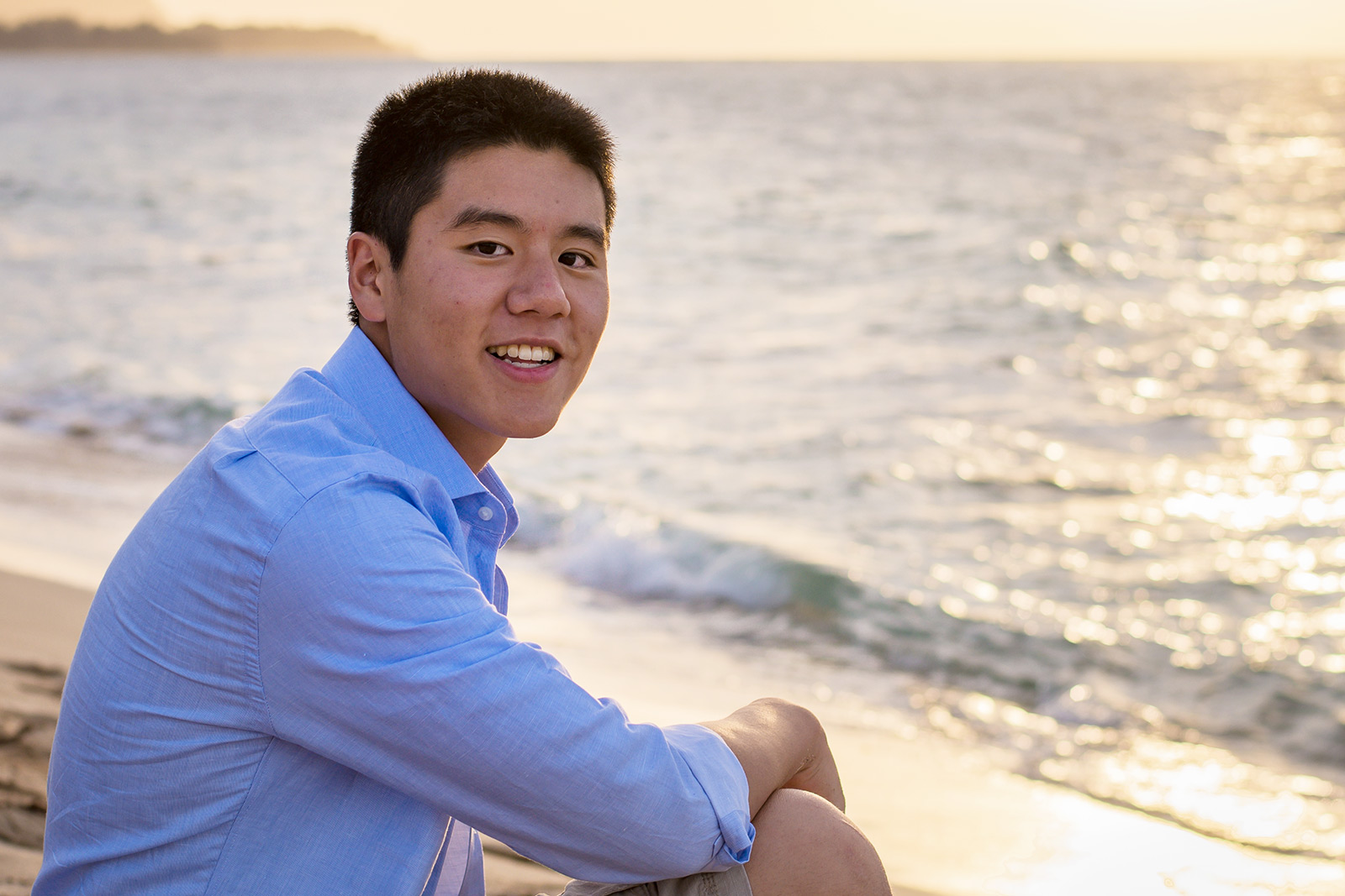 Student seated on the beach