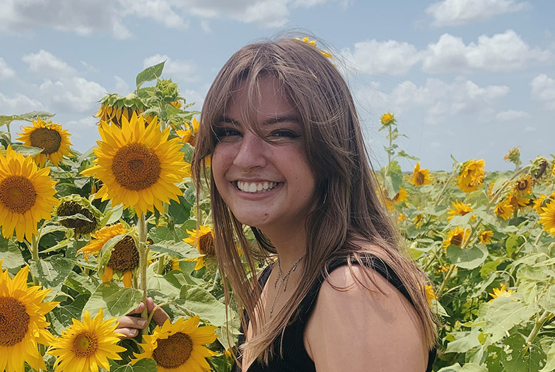 Student in field of flowers