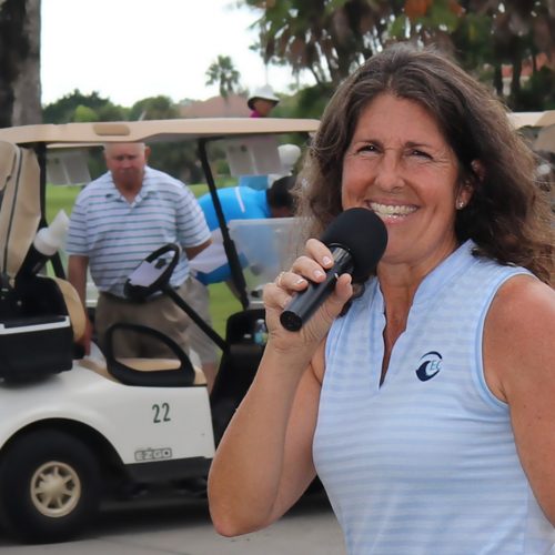 Sue McDermott emcees at memorial golf tournament