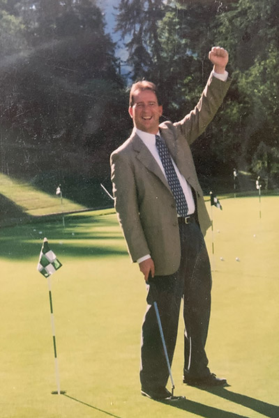 Matt McDermott celebrates sinking a long putt during a family round at a practice hole in West Virginia