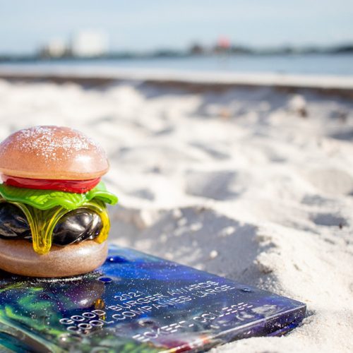 Award in shape of a hamburger sitting on sand on South Beach
