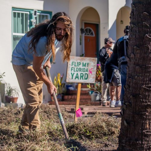 Student shoveling into yard