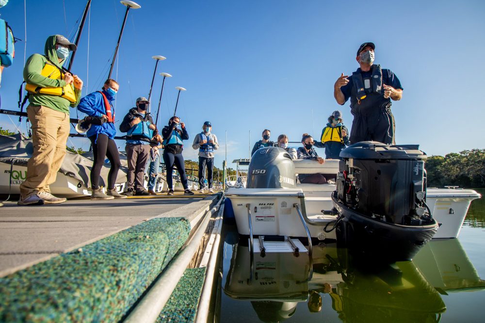 Eckerd students prepare to board a small boat