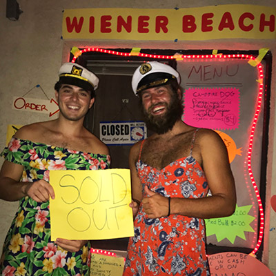 Students wearing sailor hats and holding sign that says Sold Out