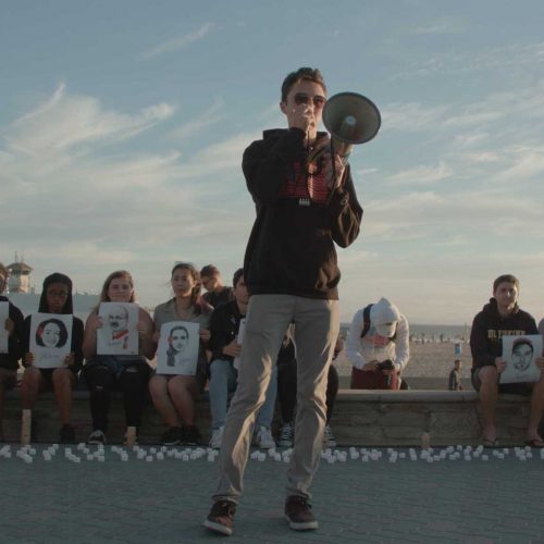 High school student speaking into bullhorn