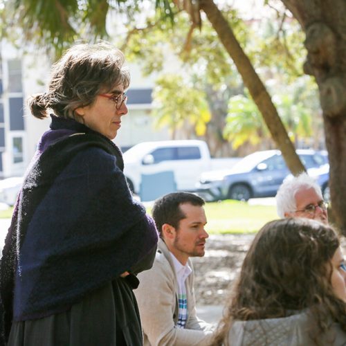 Professor standing outside in discussion with other proessors