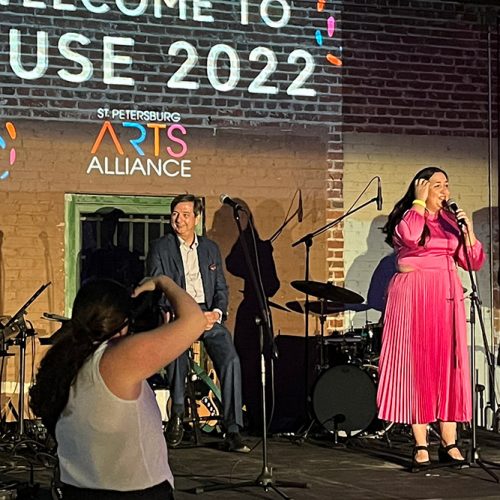 Gloria Munoz in pink dress standing on a stage