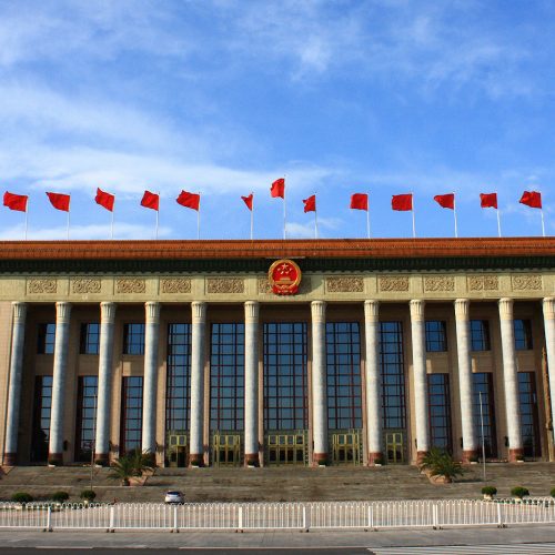 Large government building with Chinese flags