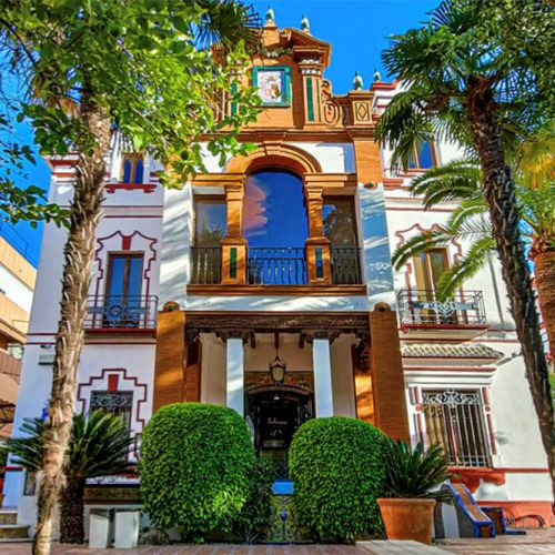 Historic building with large trees nearby