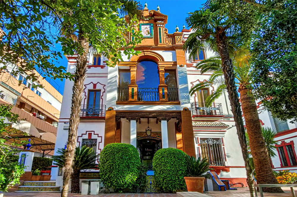 Historic building with large trees nearby