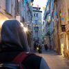 Student walking down a narrow street in France