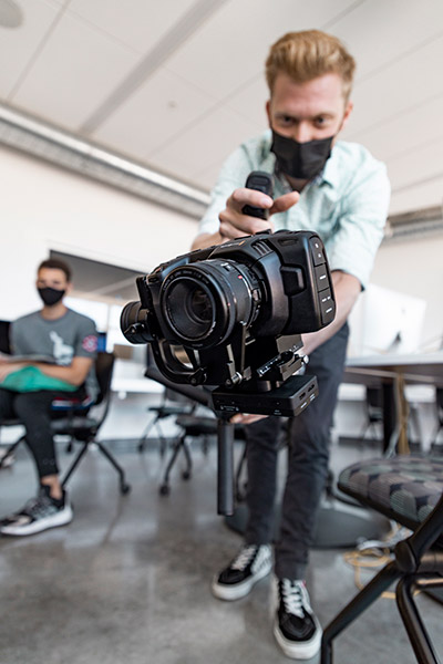 Student holding DSLR camera