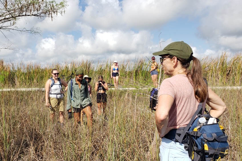 Professor in open Florida landscape teaching students