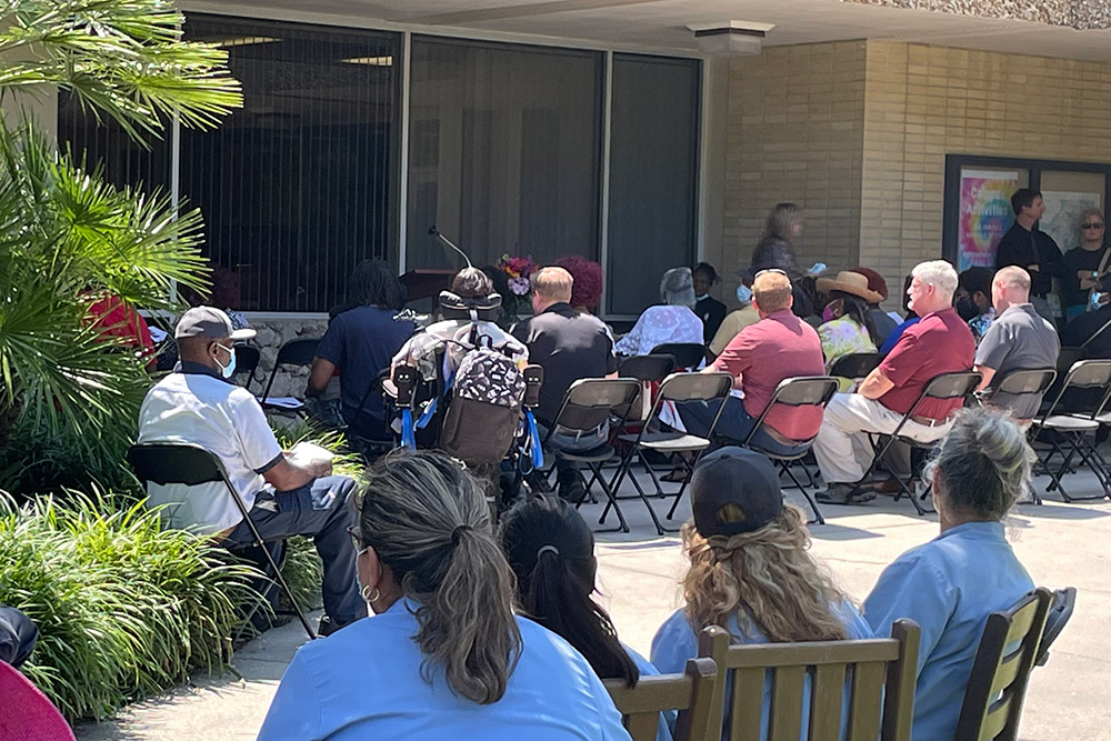 Staff gather outside