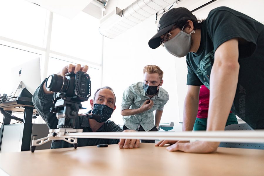 Professor showing a student how to use film equipment