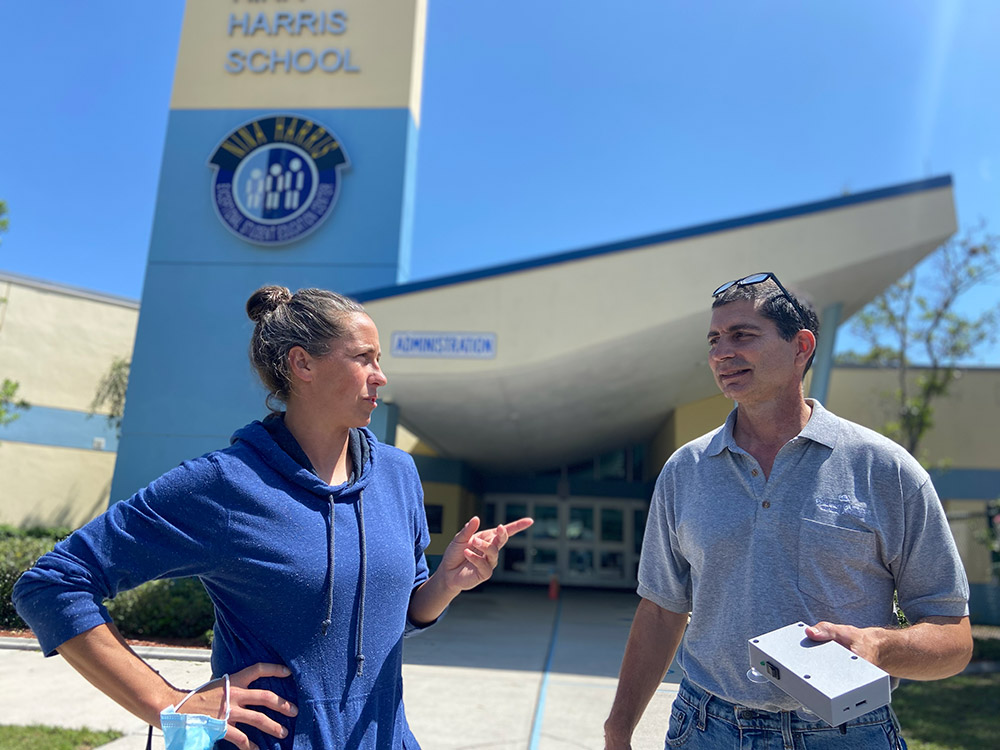 Jessie Brown and Paul Fratiello speak outside the Nina Harris building