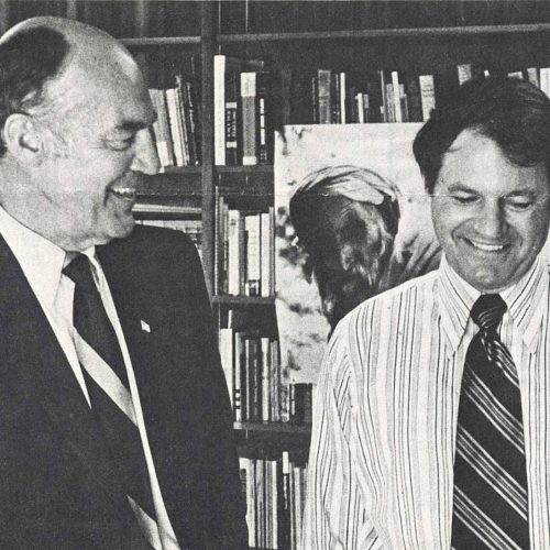 Black and white photo of Jack Eckerd speaking with Billy Wireman