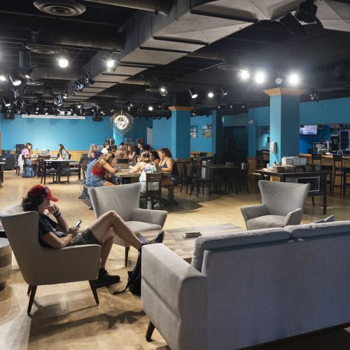 Students sitting in comfortable chairs inside a pub