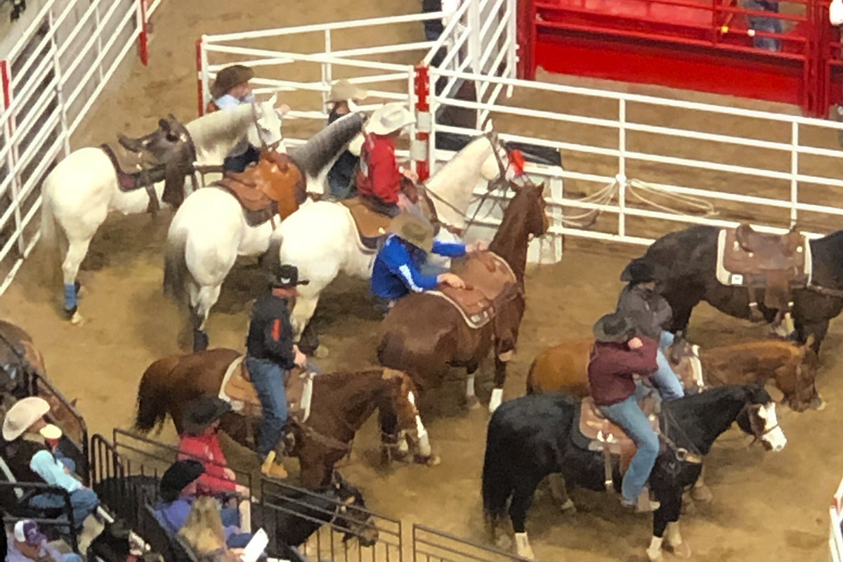 Men on horses waiting to enter the arena