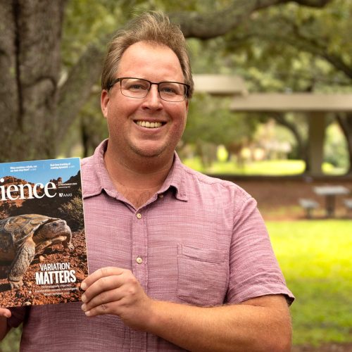 Professor holding Science Magazine