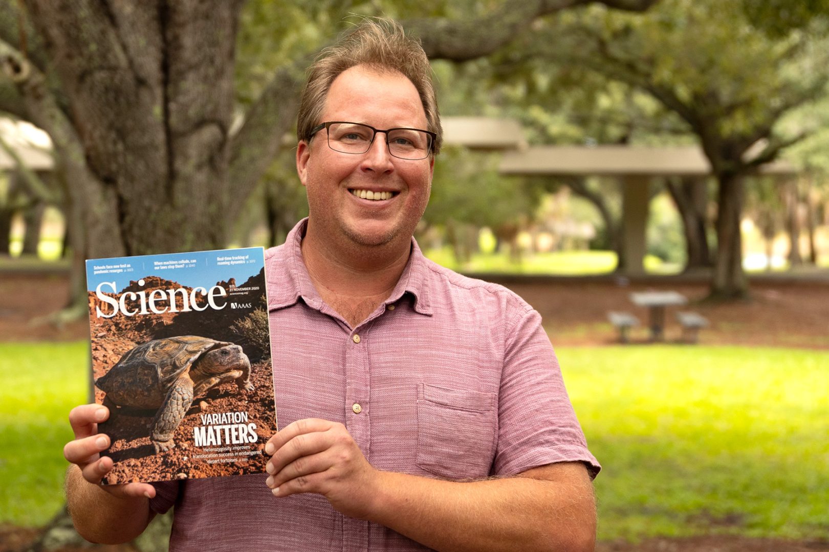 Professor holding Science Magazine