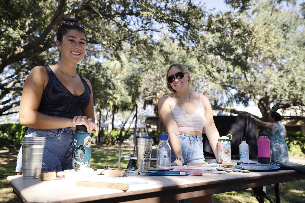 Two students at a table with reusable products