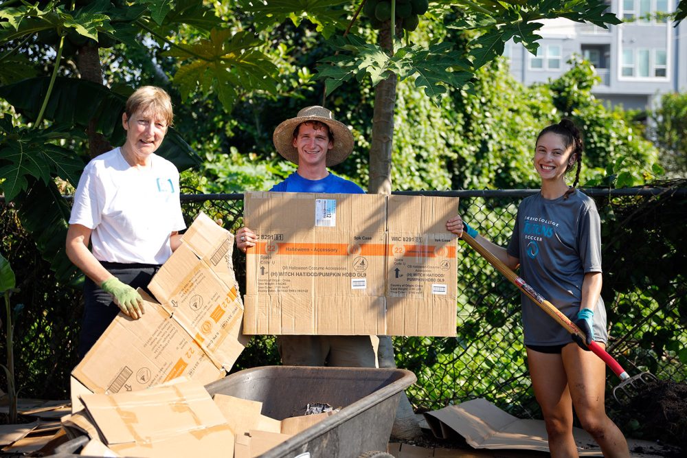 Students and ASPEC member work with cardboard