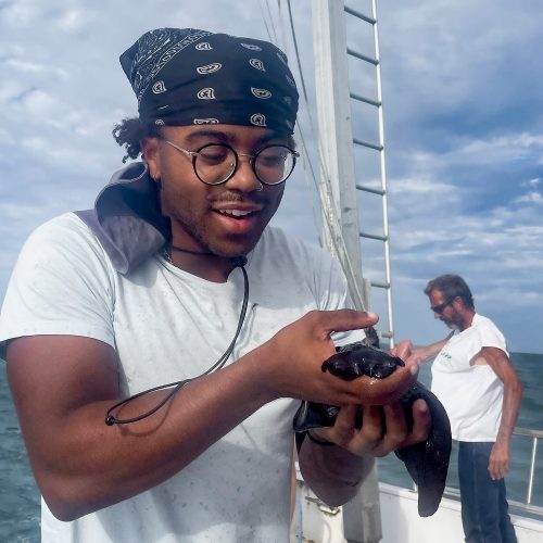 Student holding hare on ship