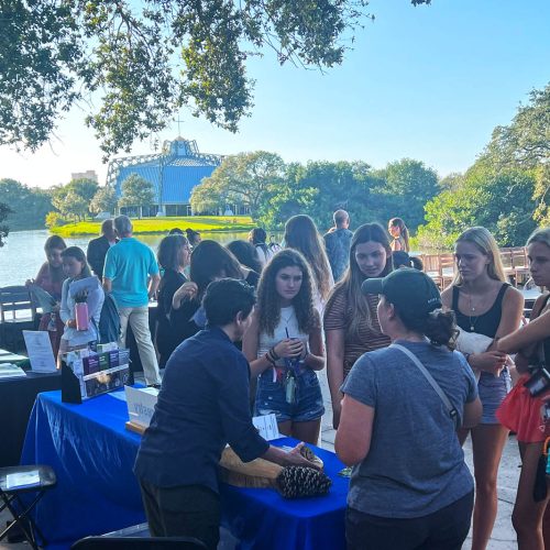 Students gather to talk with guests on the patio outside Fox Hall