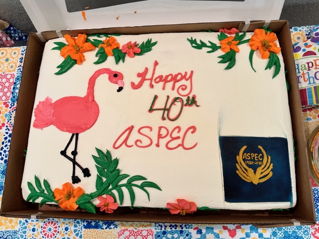 Cake that reads Happy 40th ASPEC with flamingo.