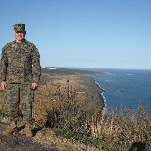 Marine standing on cliff overlooking island