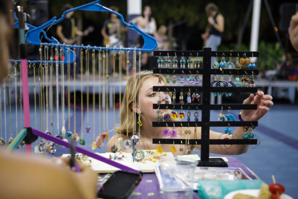 Student looking at jewelry at a table
