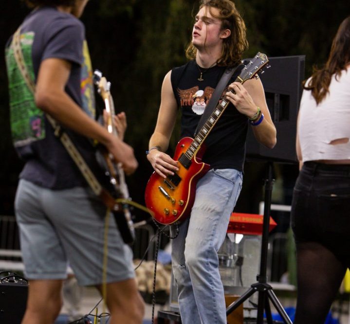 Two students playing guitar on stage