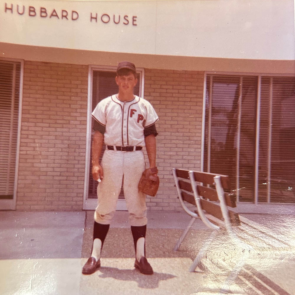 Young man in baseball attire with "FPC" on jersey