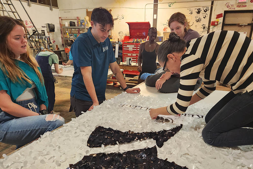 Students and staff attach materials to the float