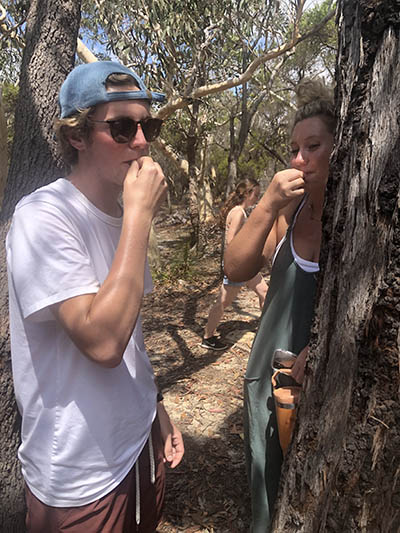 Two students eating termites in a forest