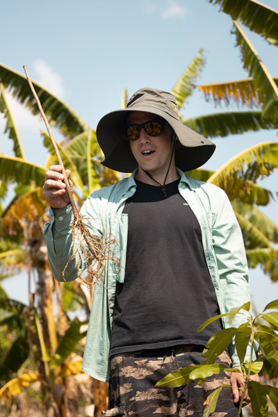 Thomas holding sapling while speaking