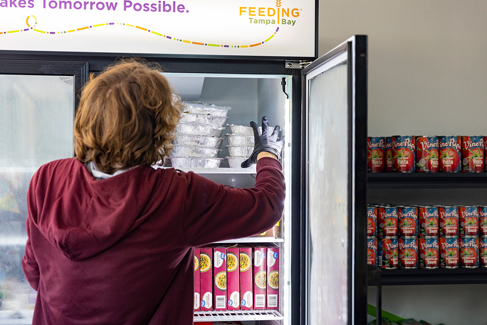 Student adds food into a refrigerator