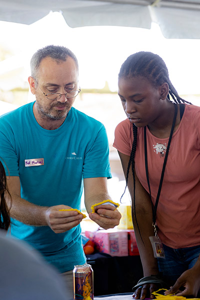 Professor showing student a geometric piece