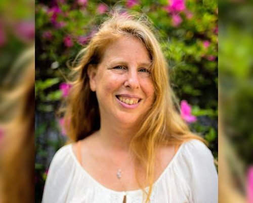 Author in front of flowers