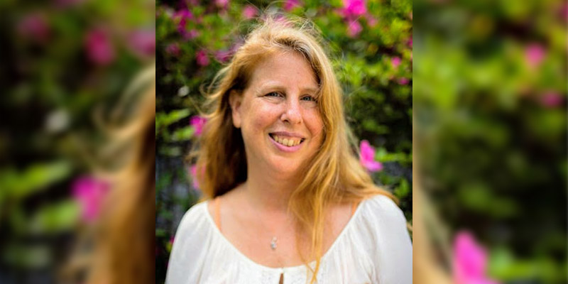 Author in front of flowers