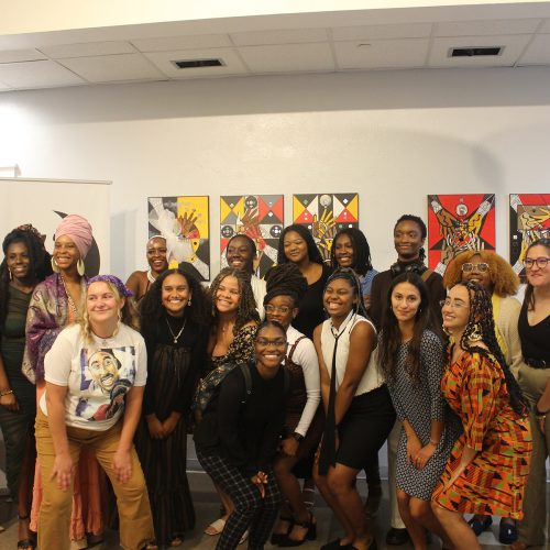 Group of Eckerd students with mentors in a museum