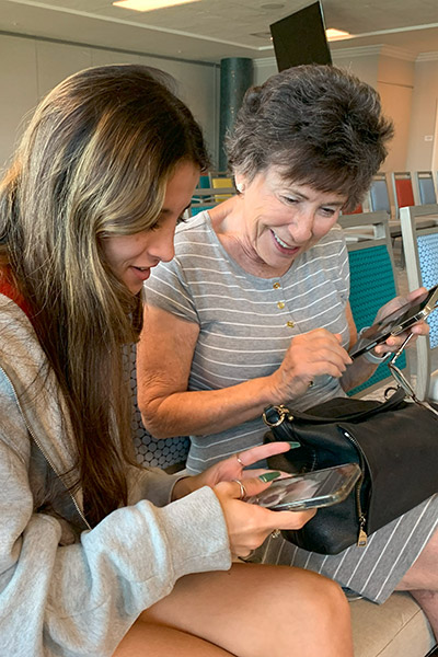 Eckerd student shows senior something on her phone