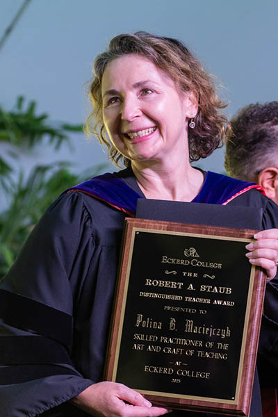 Professor holding plaque