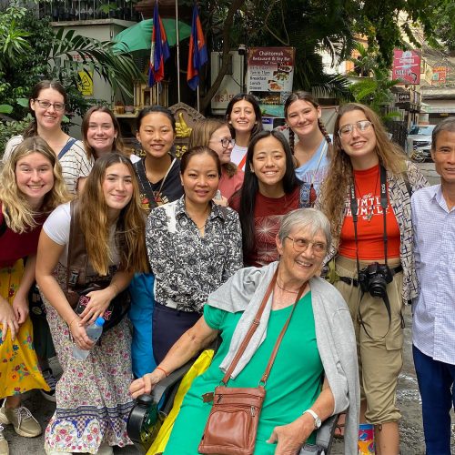 Nancy Janus, Ed.D., smiles with her students and guides during her most recent trip to Cambodia in January 2023.
