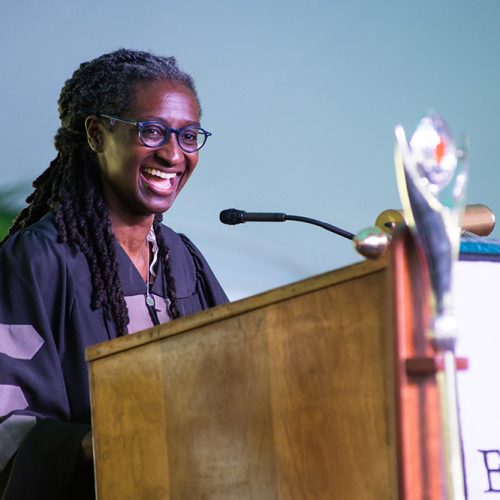 Woman wearing gown smiling at podium