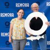 Two professors holding a giant cutouts of a circle and a remora
